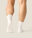 White crew grip socks above ankles with white grips and MoveActive logo on sole.