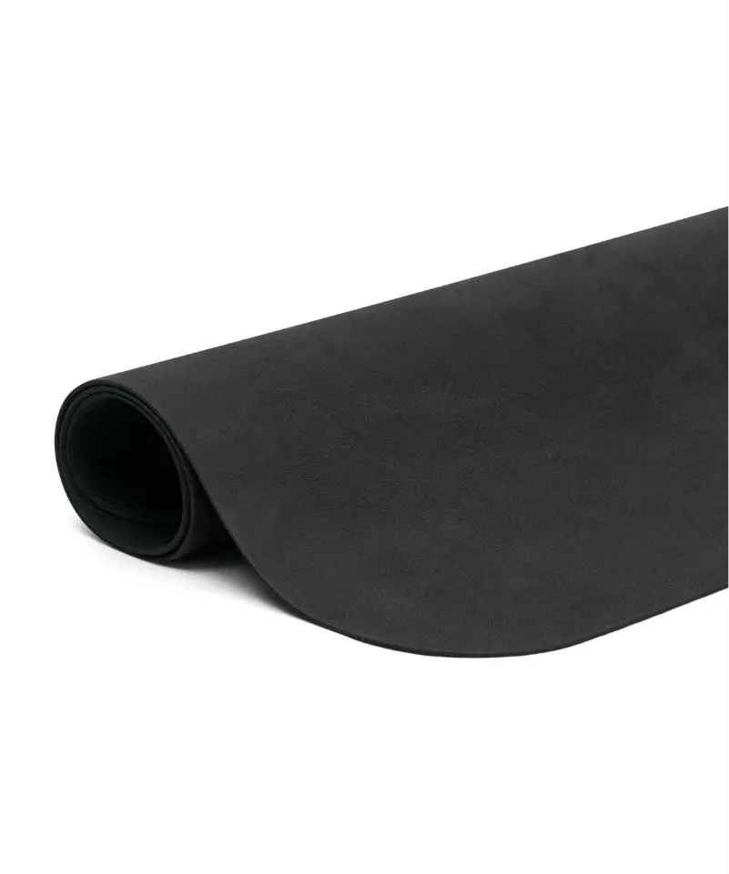 Side view of a black reformer pilates mat rolled up.