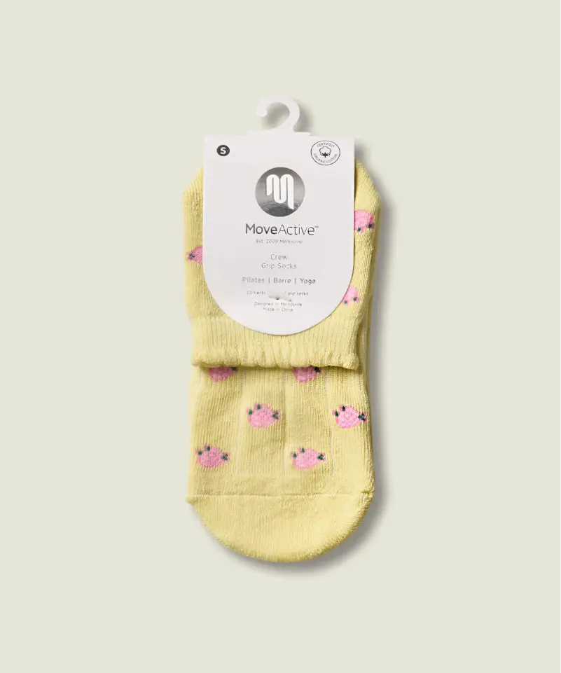 Yellow grip socks with small pink flowers in white sleeve packet with MoveActive logo.