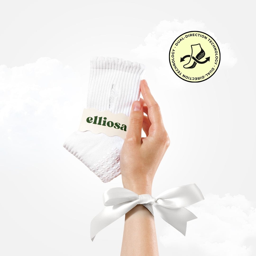 White sock with 'elliosa' label held by a hand, on a white background