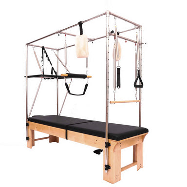Light coloured wood reformer pilates full cadillac table with black upholstery and carabiner attachments.