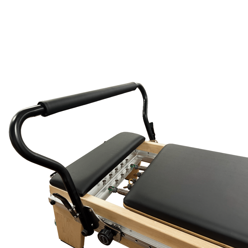 Close up of clinical pilates reformer with black upholstery and fully adjustable footbar.