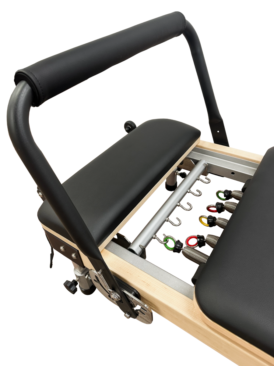 Close up view of lightweight pilates reformer showing 5 colour coded springs.