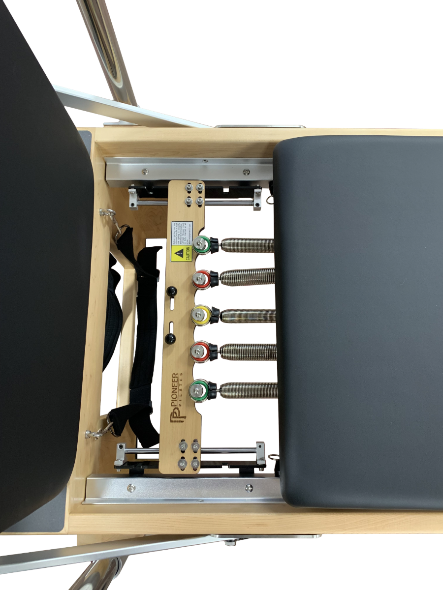 Close up of pilates reformer showing 5 colour coded springs.