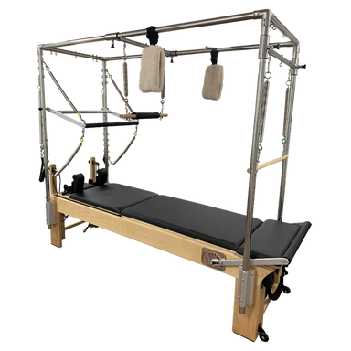 Light coloured wooden pilates reformer with black upholstery, with full metal trapeze and attachments.