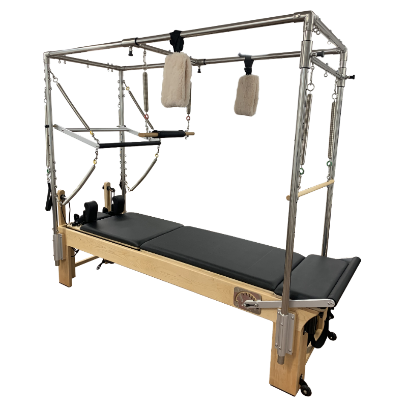 Light coloured wooden pilates reformer with black upholstery, with full metal trapeze and attachments.