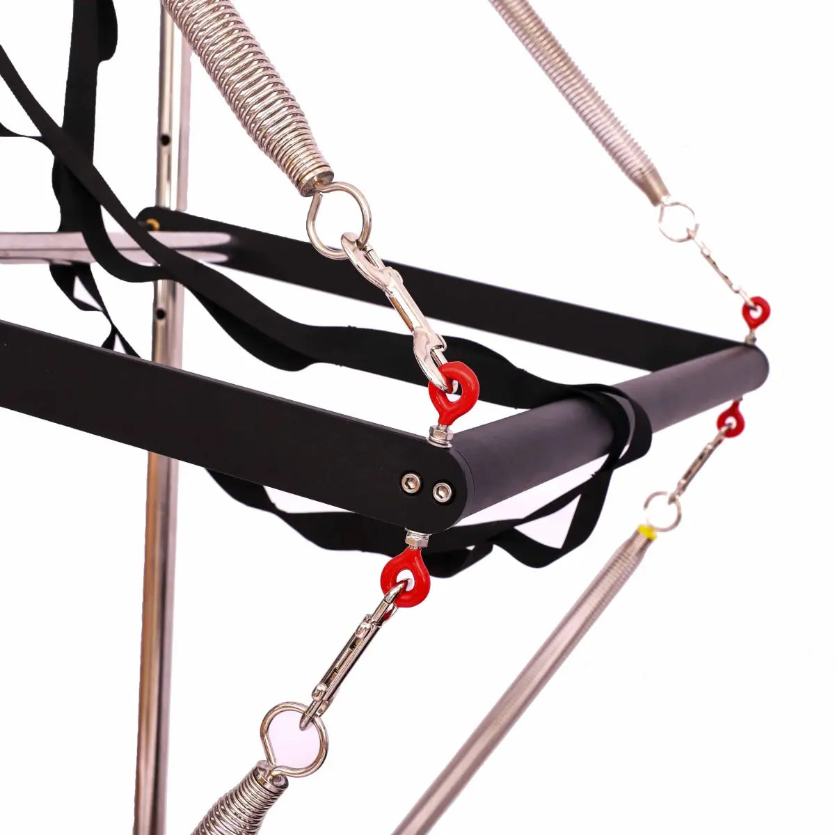 Close up of black bar attached to 4 springs as part of the trapeze attachment on a half trapeze reformer.