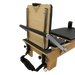 Close up of the board at the end of the reformer table showing the black footbar and black upholstery.