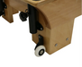 Close up of the feet of a pilates reformer with white wheels.
