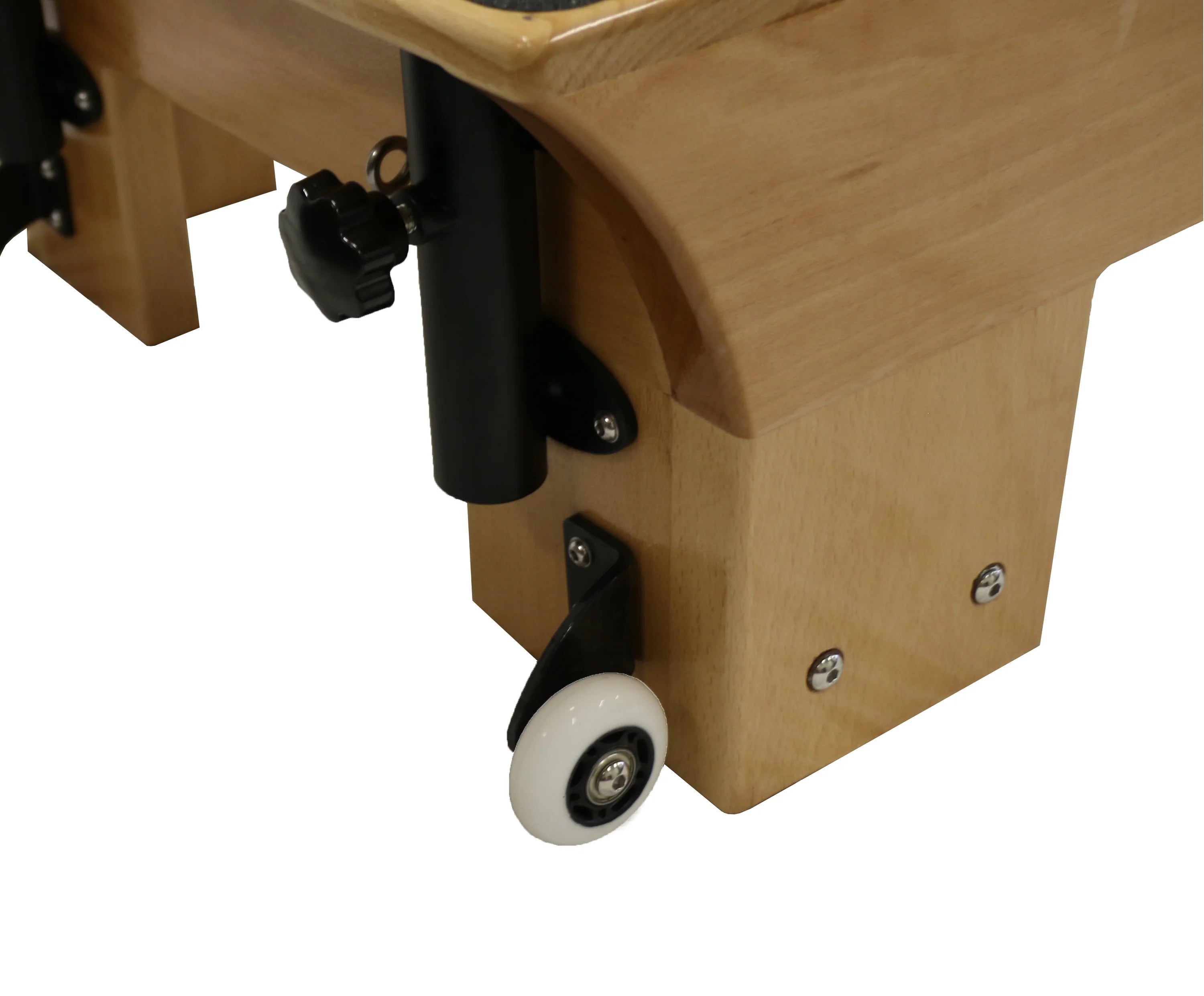 Close up of wooden reformer pilates machine foot, with white wheel for moving the machine.
