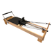 wooden pilates reformer with black upholstery and adjustable footbar,.