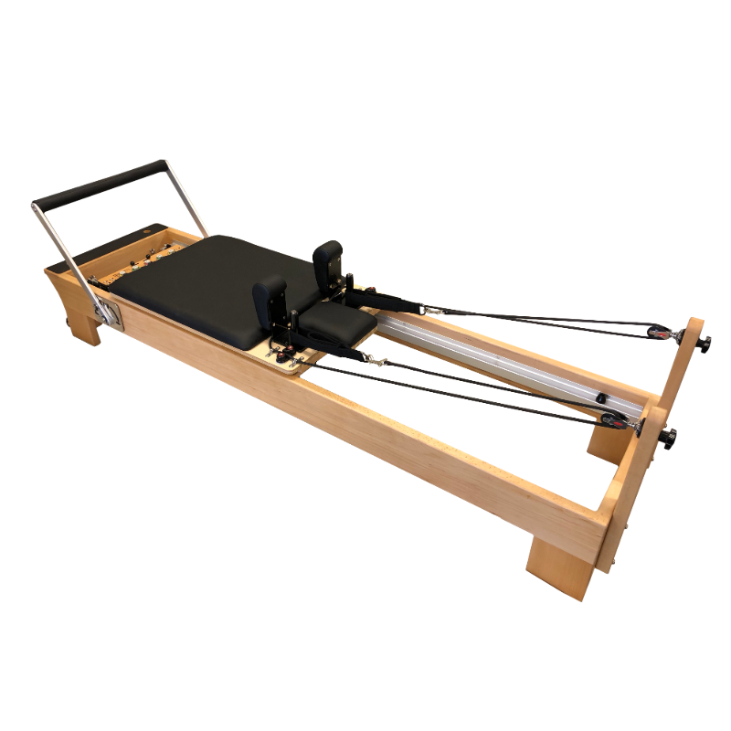 light coloured wooden pilates reformer with black upholstery and adjustable foot bar.