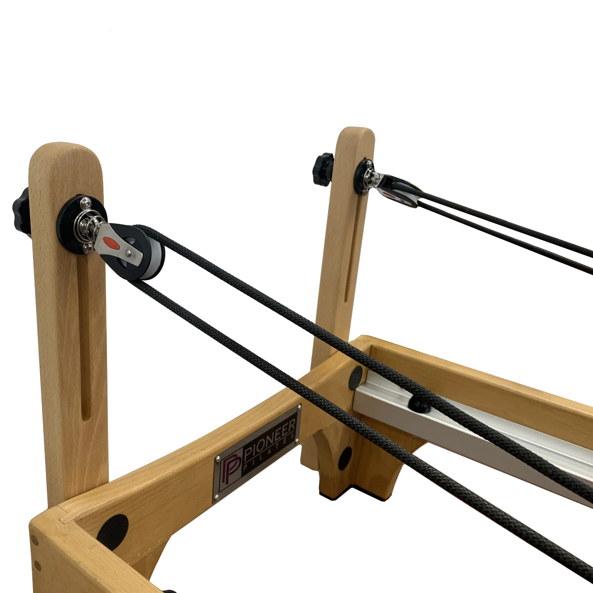 Close up of wooden reformer pilates machine showing cables and pulleys.