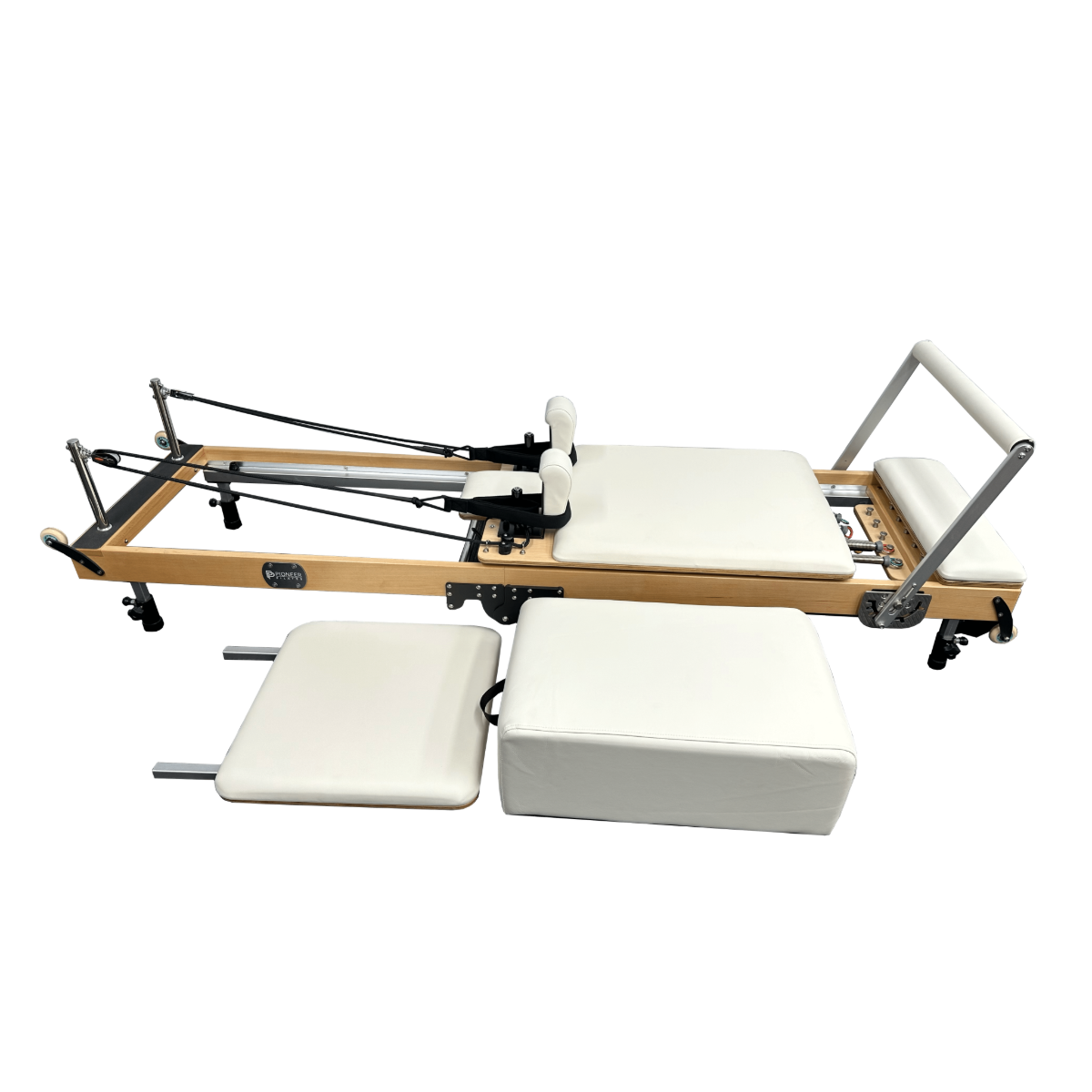Foldable Pilates reformer machine with sitting box and springboard in white upholstery.