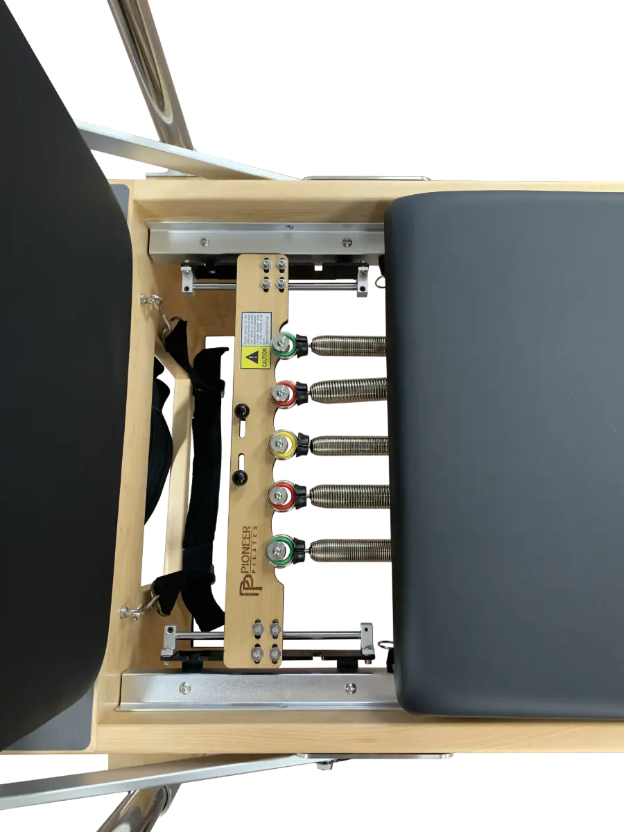 Close up of pilates reformer showing 5 colour coded springs.