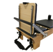 close up of foot end of wooden reformer pilates machine showing white wheels, adjustable footbar and jump board attachment.