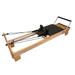 PP-03 light coloured wooden pilates reformer with black upholstery and adjustable foot bar.