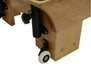 Close up of wooden reformer pilates machine foot, with white wheel for moving the machine.
