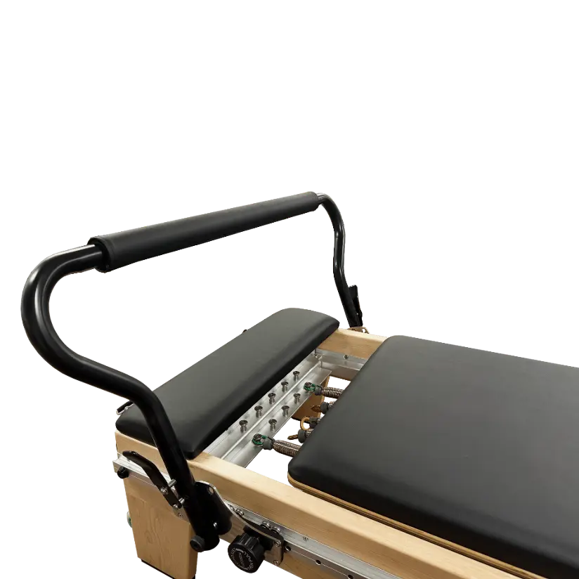 Close up of clinical pilates reformer with black upholstery and fully adjustable footbar.