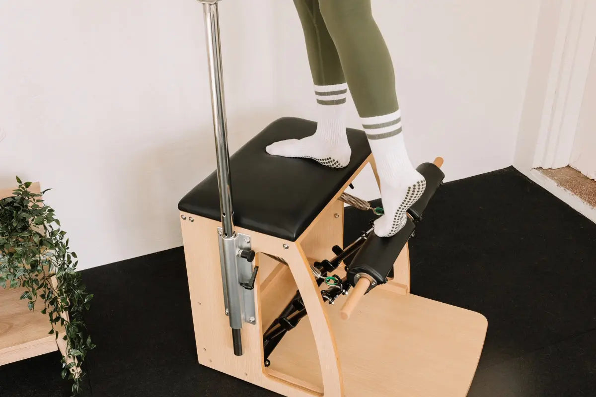 Woman standing on a Pilates Wunda Chair 