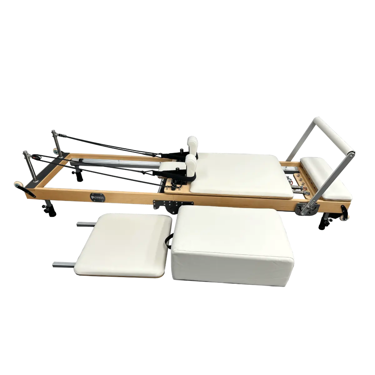 Foldable Pilates reformer machine with sitting box and springboard in white upholstery.