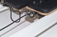 Close up of the cleat rope lock mechanism on the Queen 2.0 Pilates reformer with white frame and black upholstery.