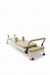 Core Collab Queen 2.0 Pilates reformer with white frame and beige upholstery in a studio setting with an arched window.