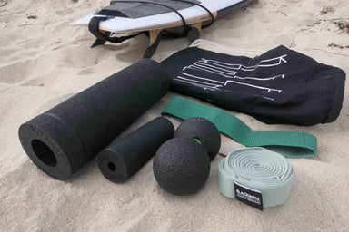 Surf travel set showing the carry bag, 2 travel sized foam rollers, a duo massage ball and 2 resistance bands.