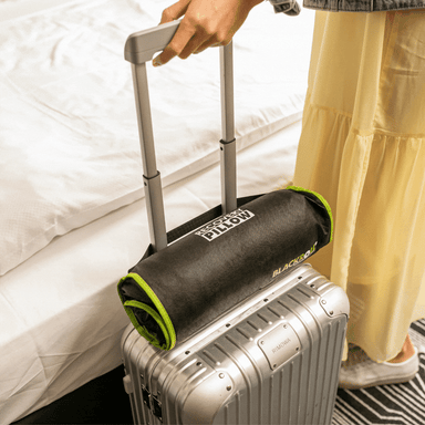 A video showing the blackroll travel pillow and fascia gun being taken traveling in multiple locations including on the plane and camping.