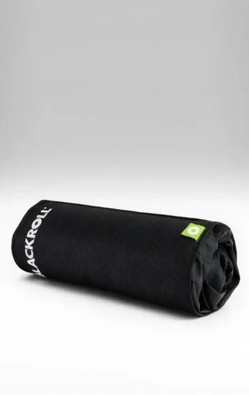 A kids size Blackroll recovery pillow rolled up inside the black cover.