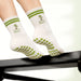 Elliosa Pilates Paradise socks worn on person using a reformer.