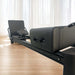angle view of the core collab queen Pilates reformer in black frame and black upholstery with jumpboard and sitting box.